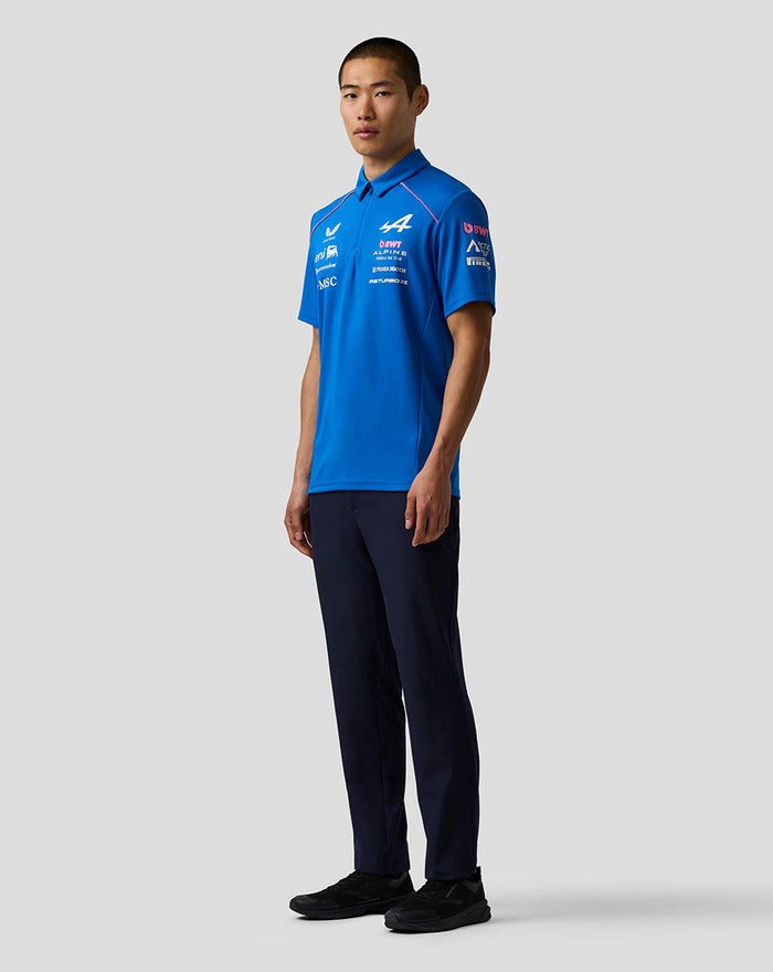 Male model wearing Official Men’s BWT Alpine Formula One Team Polo Shirt in blue with team logos on the chest.