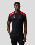 Front view of a model wearing the Official Haas Team Driver T Shirt in black with red shoulder panels and chest logos.