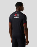 Back view of a model wearing the Haas Team Driver T Shirt in black with red shoulders and Haas branding on the back.