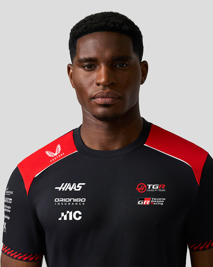 Male model wearing Official Haas Team Men's Driver T Shirt black with red shoulder panels and front sponsor logos