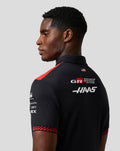 Back view of a model wearing the Haas Team Short Sleeve Polo with logos on back and red shoulder details