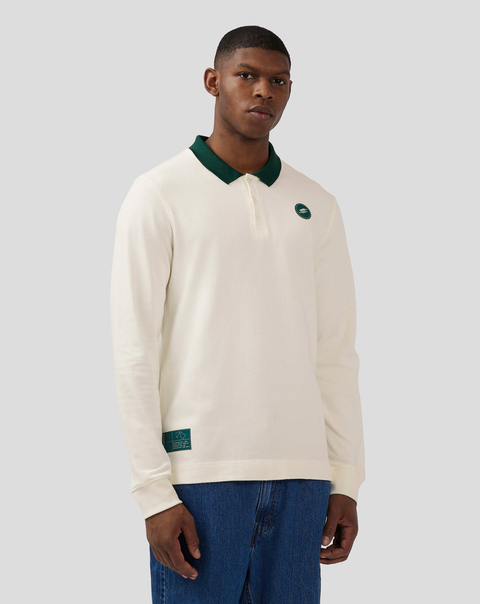 Back view of a model wearing a Coconut Milk long sleeve polo with a dark green collar