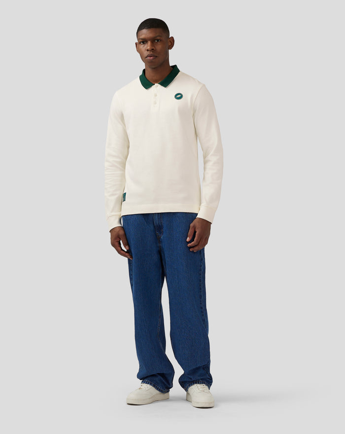 Male model wearing Unisex Silverstone Heritage Long Sleeve Polo in Coconut Milk with dark green collar and chest logo.