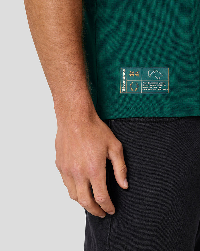 Close-up of green Heritage Polo hem area showing a small brand patch.