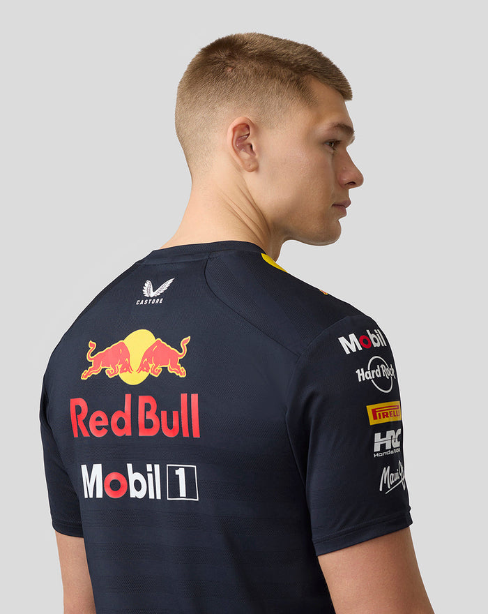 Back view of a model in night sky navy Set Up T Shirt with a prominent Red Bull logo across the back and sponsor logos on the sleeves.
