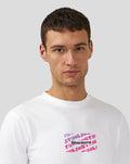 Front close up of white Festival graphic T shirt showing a purple pink text square on the chest.