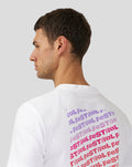 Back view of a white unisex Festival graphic T shirt with a purple stacked text block on the back.