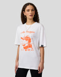 Woman wearing a white oversized Oracle Red Bull Racing Max Verstappen puzzle T shirt with an orange grid graphic