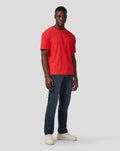 Male model wearing flame scarlet Oracle Red Bull Racing oversized T-shirt with dark jeans.