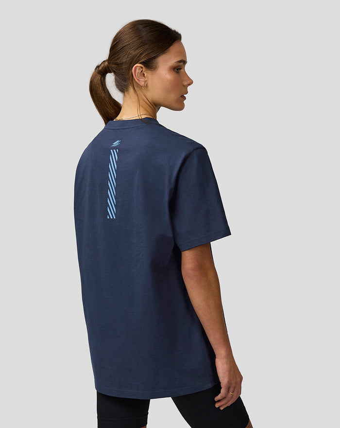 Back view of a woman in a navy Core Track Graphic T-Shirt with a light blue striped graphic down the back.