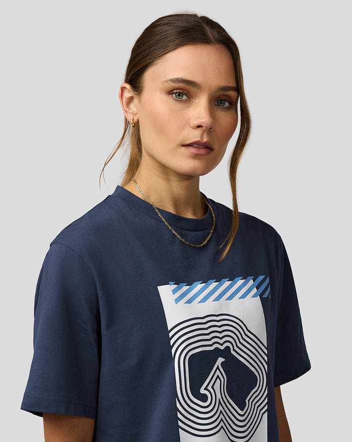 Close up of a woman wearing a navy Silverstone Core Track Graphic T Shirt with a bold white graphic and blue diagonal accents.