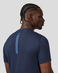 Profile view of a model in the Black Iris T-Shirt showcasing the front graphic and relaxed fit