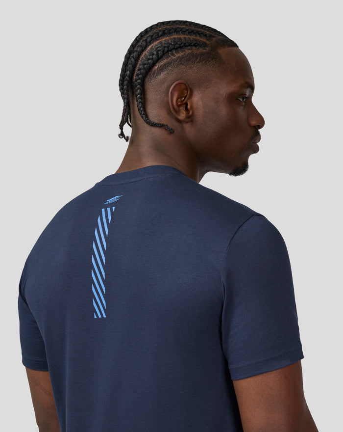 Profile view of a model in the Black Iris T-Shirt showcasing the front graphic and relaxed fit