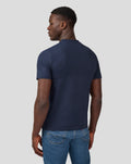 Back view of a man wearing a navy Silvertone Core T Shirt with blue jeans