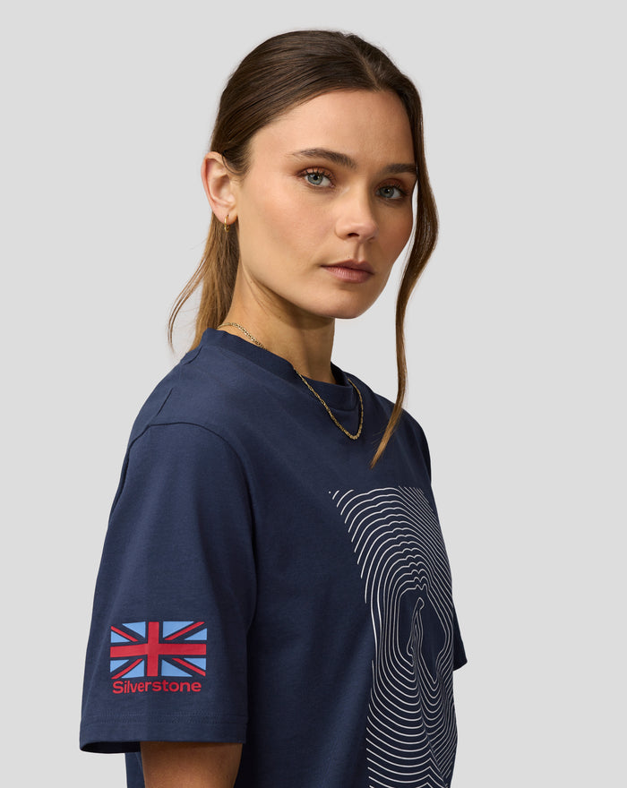 Portrait of a woman in a navy Silvertone Core T Shirt with a circular wave graphic and Union Jack patch on the sleeve