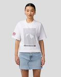 Woman model wearing white Silverstone Core T Shirt with front graphic and sleeve flag patch