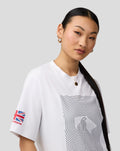 Close up of a woman wearing a white Silverstone Core T-Shirt with a circular front graphic.