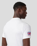 Side view of model wearing white Silverstone Core T-Shirt with Union Jack patch on the sleeve