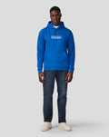 Front view of a man in a blue Silverstone Core Hoodie with white coordinates graphic on the chest