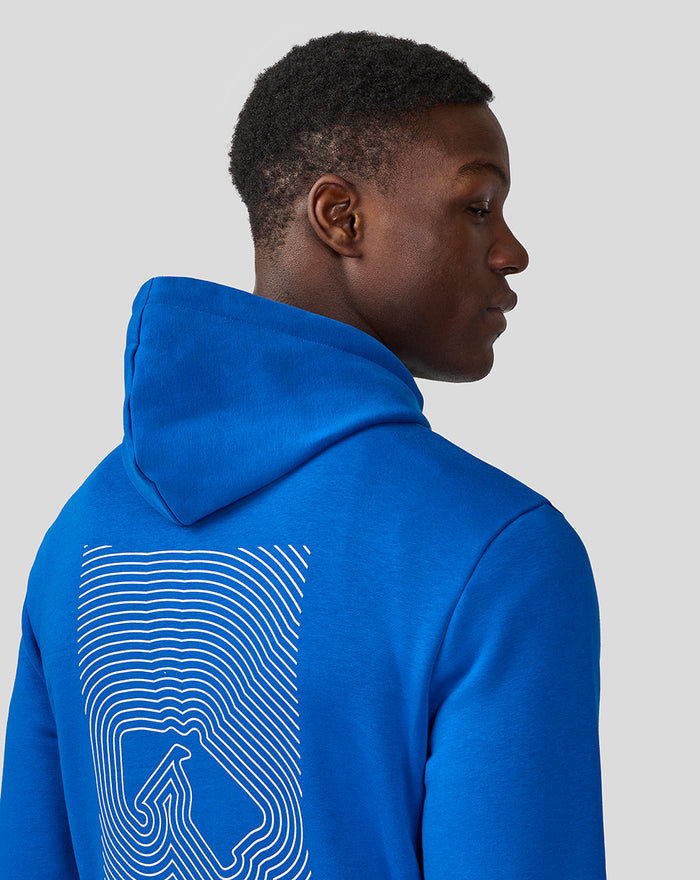 Back view of a man in a blue Silverstone Core Hoodie showing a large white line art graphic on the back.