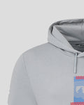 Close-up of chest graphic on the Weathervane hoodie showing a blue panel with red diagonal stripes and a hood edge visible