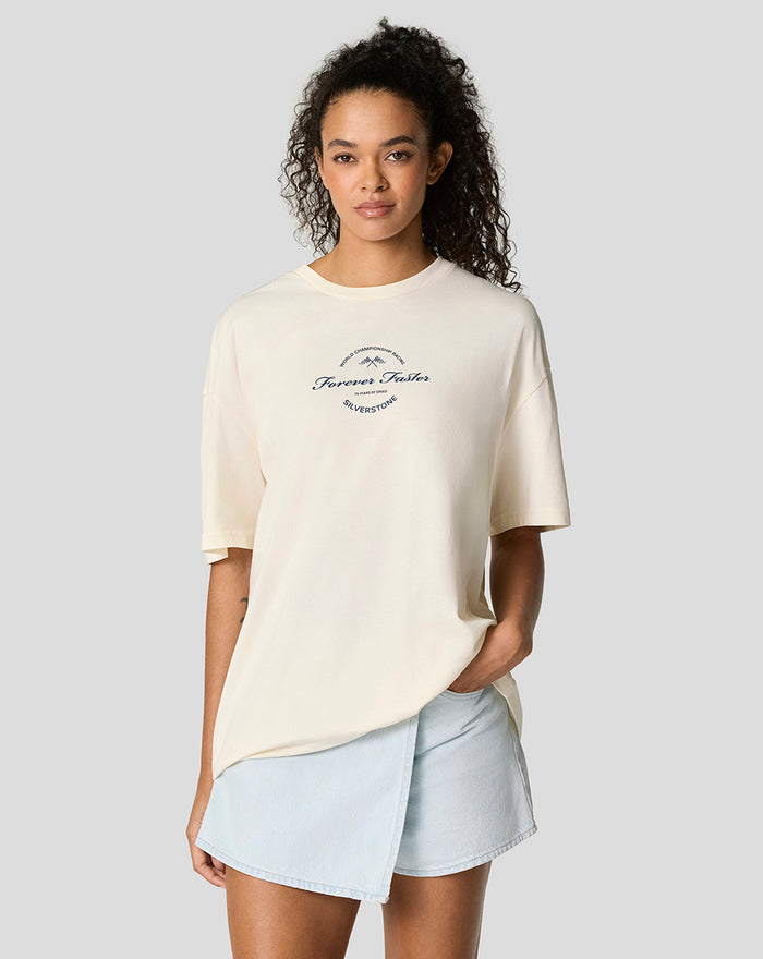 Woman wearing an oversized Egret T shirt with screen print graphic and woven badge, paired with light denim shorts.