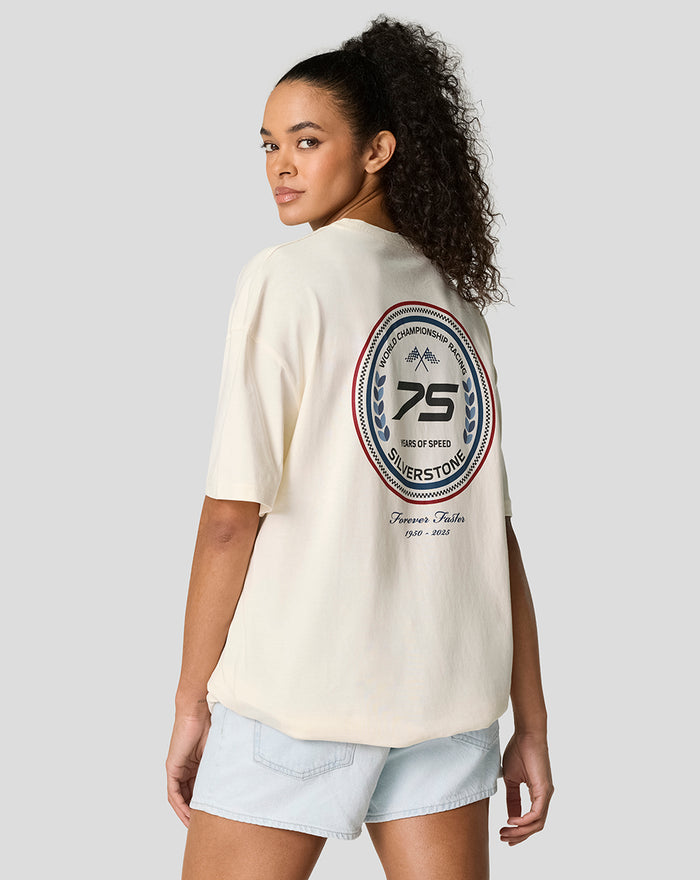 Angled back view of a model in a cream oversized T shirt with a circular patch on the back