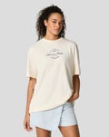 Model wearing cream oversized T-shirt with a central circular World Championship Racing Forever Faster graphic and Silverstone branding