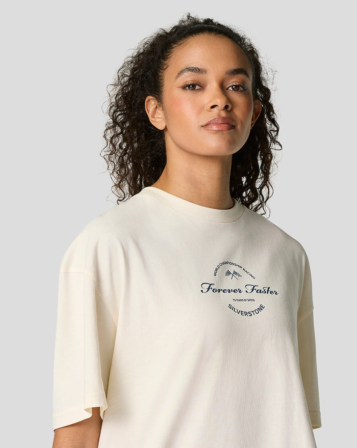 Model wearing a cream oversized T shirt with a circular Forever Faster chest logo