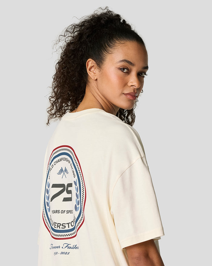 Back view of a model in a cream oversized T shirt with a large circular 75 Years Silverstone patch on the back