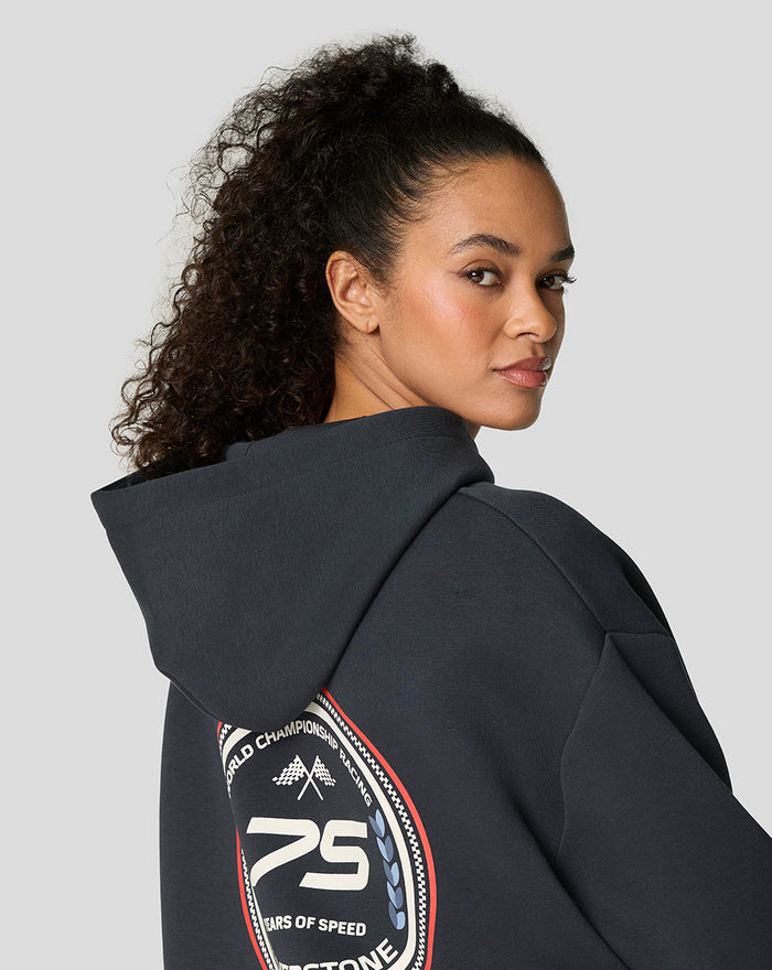 Back view of dark navy oversized hoodie with large round patch depicting 75 years of speed