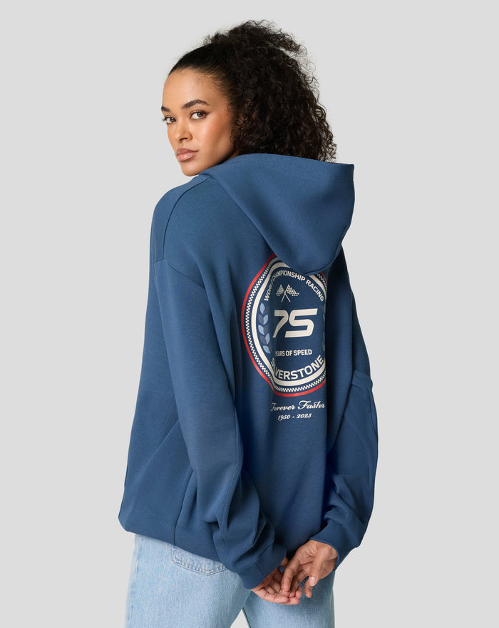 Three quarter back view of a model in a blue Sargasso Sea hoodie showing the large back patch.