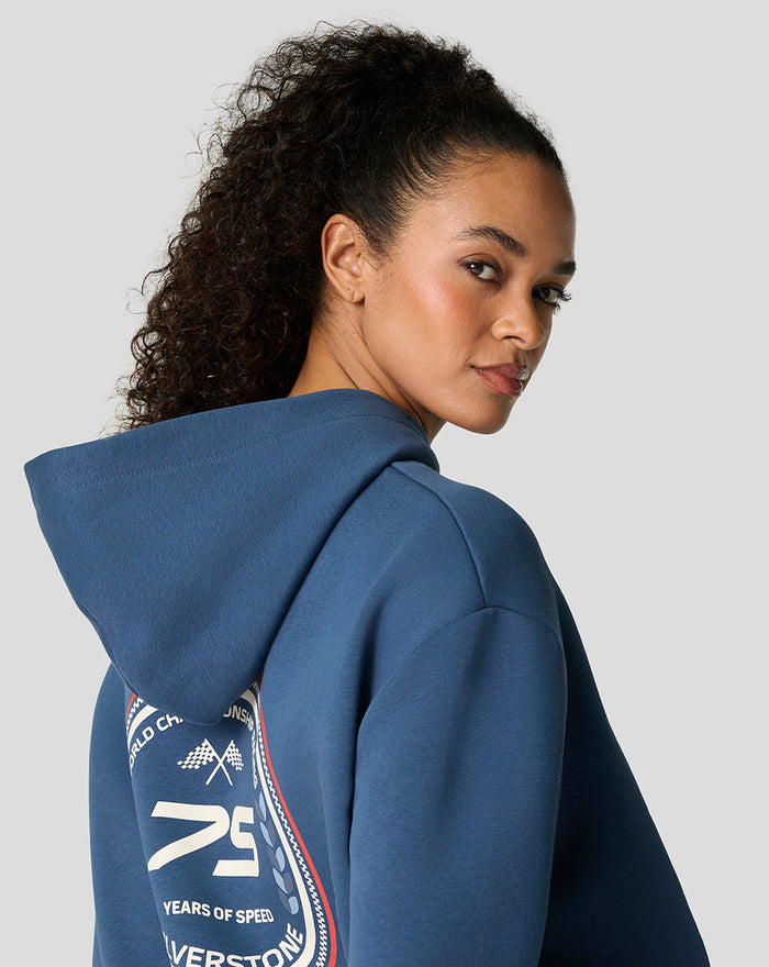 Back view of a model wearing a blue Sargasso Sea hoodie with a large circular patch on the back.