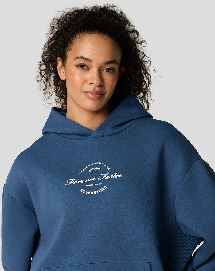 Front view of blue oversized hoodie showing chest logo and kangaroo pocket details