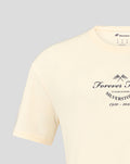 Model wearing cream oversized T shirt with Forever Faster graphic centered on the chest