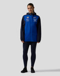 Model wearing Oracle Red Bull Racing Teamline Water Resistant Jacket in Night Sky blue with navy sleeves