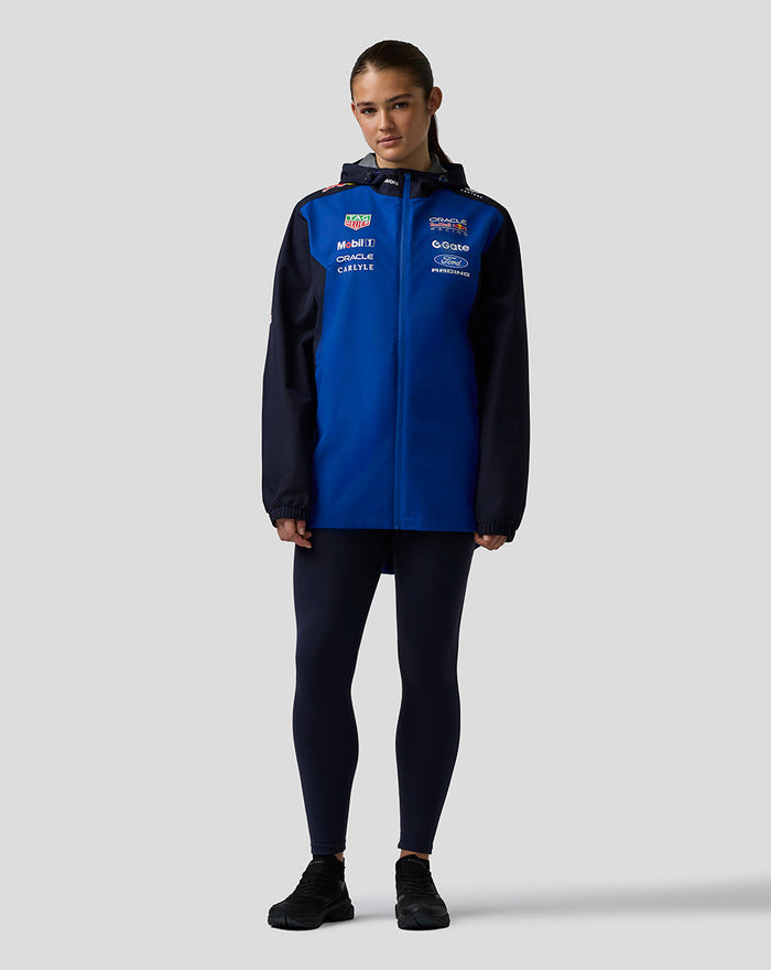 Model wearing Oracle Red Bull Racing Teamline Water Resistant Jacket in Night Sky blue with navy sleeves