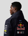 Rear view of a model in the Night Sky Teamline jacket showing a large Red Bull logo on the back and sponsor decals on the sleeves.