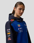 Female model wearing the Night Sky Oracle Red Bull Racing Teamline water resistant jacket with sponsor logos on the chest.