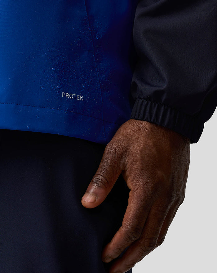 Blue Oracle Red Bull Racing Teamline water resistant jacket close-up showing ProTek branding at the front hem