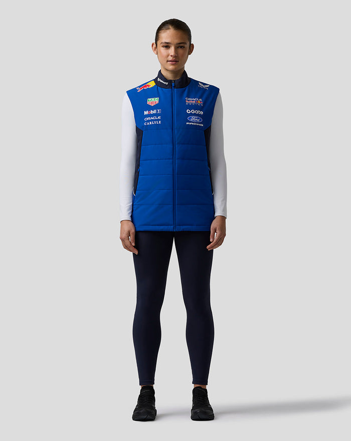 Front view of a model wearing the blue Oracle Red Bull Racing Teamline Gilet with prominent branding and a front zipper