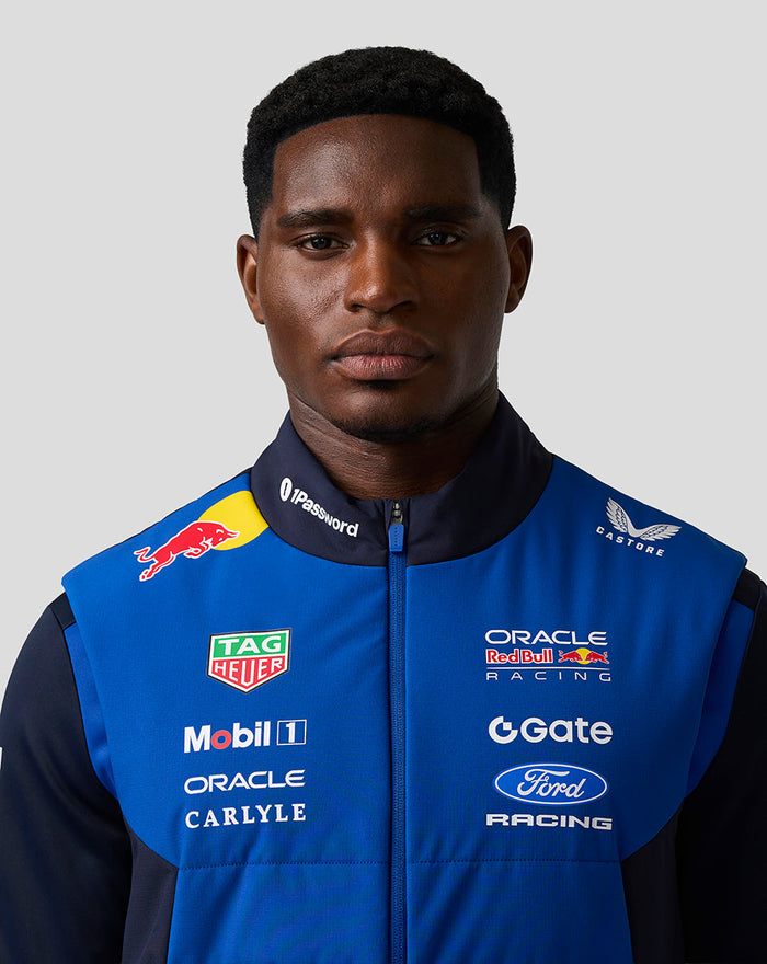 Male model wearing blue Night Sky Oracle Red Bull Racing Teamline Gilet with sponsor logos on the chest.