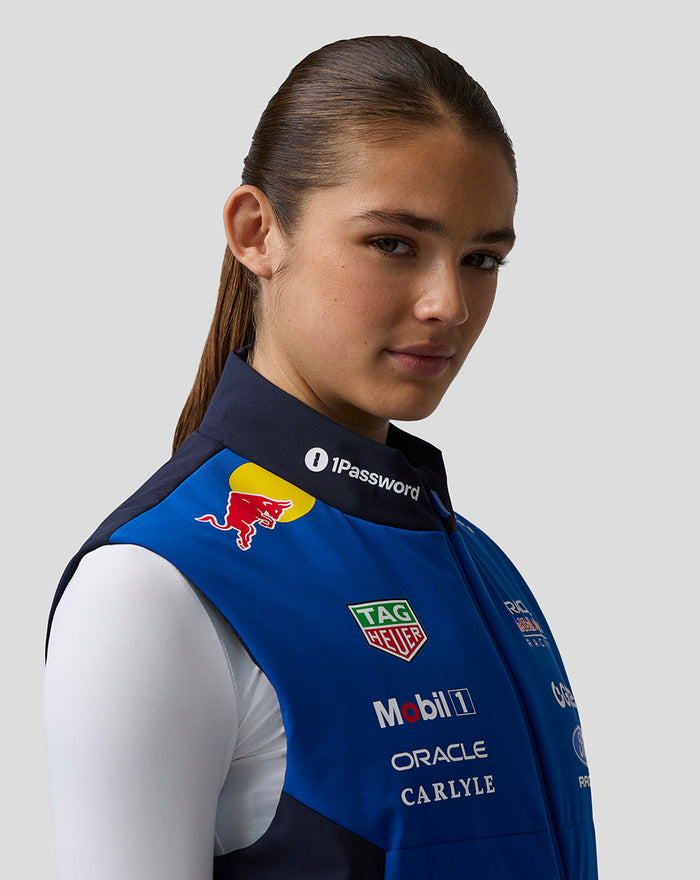 Female model in blue Night Sky Oracle Red Bull Racing Teamline Gilet displaying branding and patches on the chest.