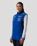 Front view of a model wearing the Oracle Red Bull Racing Teamline Gilet in Night Sky blue with chest logos.