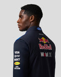 Back view of a male model wearing the Oracle Red Bull Racing Teamline Gilet in night sky blue with a large Red Bull logo on the back