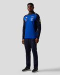Male model wearing navy and blue Oracle Red Bull Racing Teamline quarter zip midlayer boasting sponsor logos on chest and sleeves