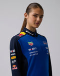 Female model wearing Oracle Red Bull Racing Teamline Quarter Zip Midlayer in Night Sky blue with navy sleeves and branding on the chest