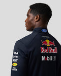 Back view of a male model in a navy teamline midlayer with Ford logo at the collar and prominent Red Bull branding on the back.