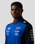 Male model wearing Oracle Red Bull Racing Teamline Quarter Zip Midlayer in Night Sky blue with navy sleeves and front sponsor logos