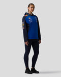 Female model wearing navy and blue Oracle Red Bull Racing Teamline Overhead Hoodie with sponsor logos on the chest and sleeves